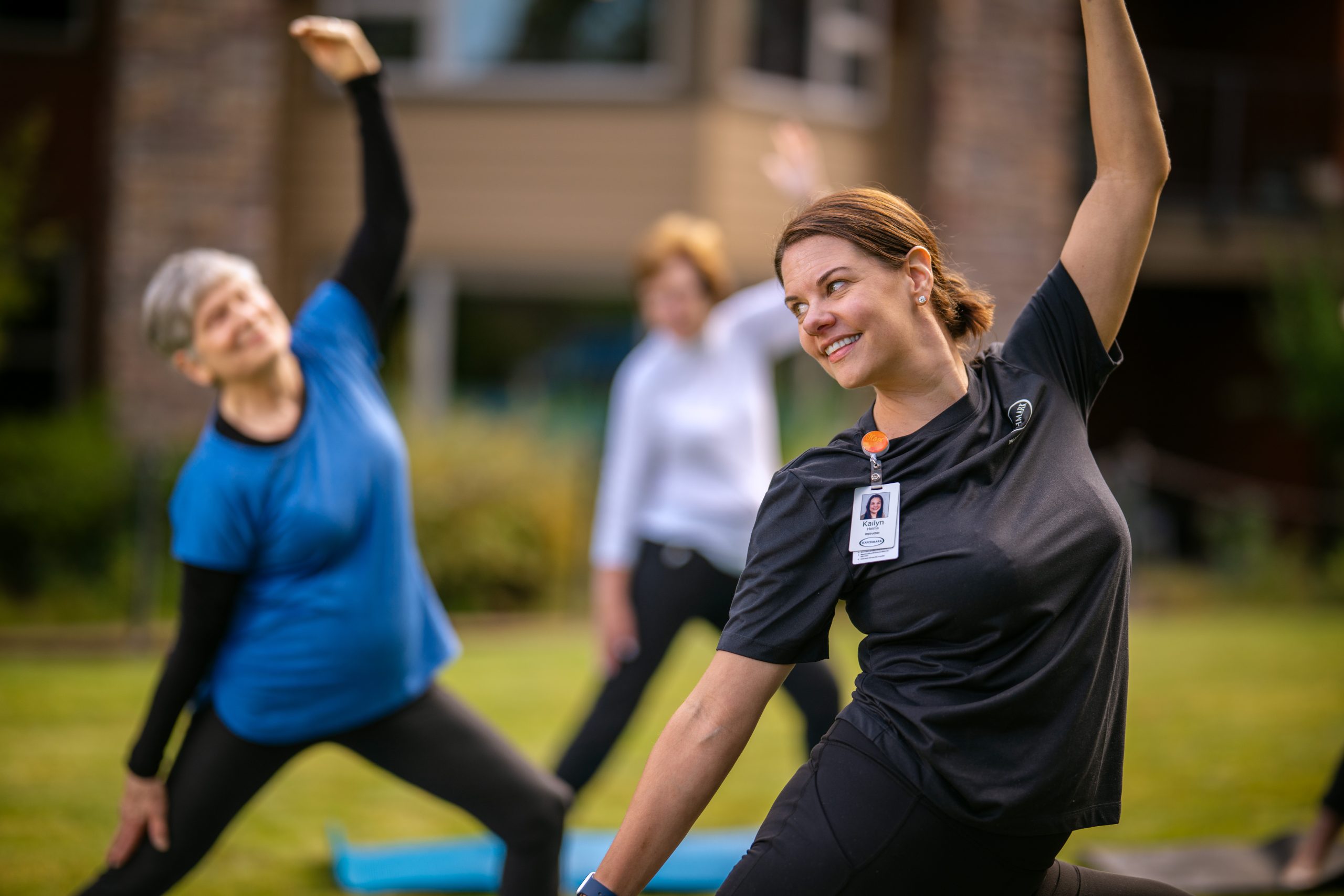 Touchmark team member leading residents in yoga class.